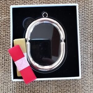 Silver Oval Keychain with Red and Yellow Straps